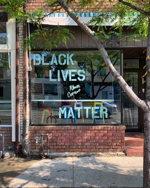 Black Lives Matter written in blue paint in store window