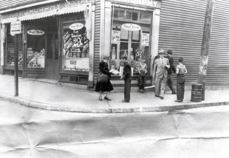 Historical black and white image people standing outside of Murphy Store